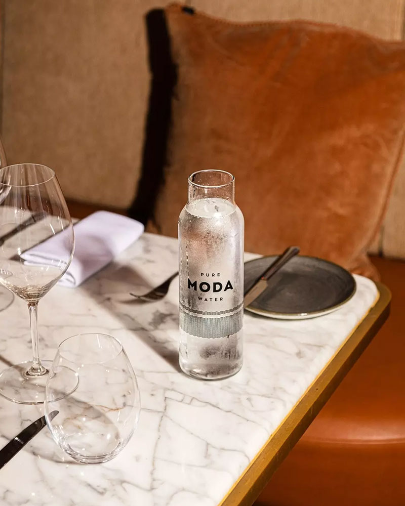 MODA bottles poured at a set restaurant table
